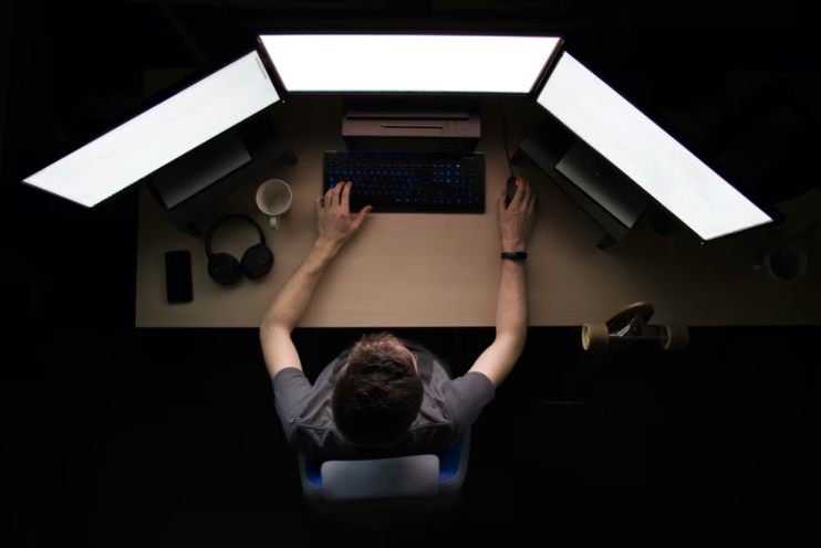 Person working with several screens